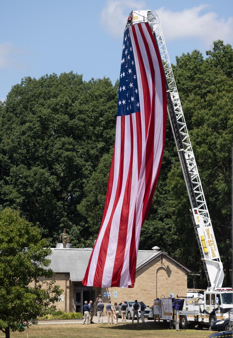 An American flag flies, attached to a fire truck, at Cabot United Methodist church Friday, July 19, for the funeral of Corey Comperatore, the Buffalo Township man killed at Saturday's rally for former President Donald Trump from a would-be assassin's stray bullet.