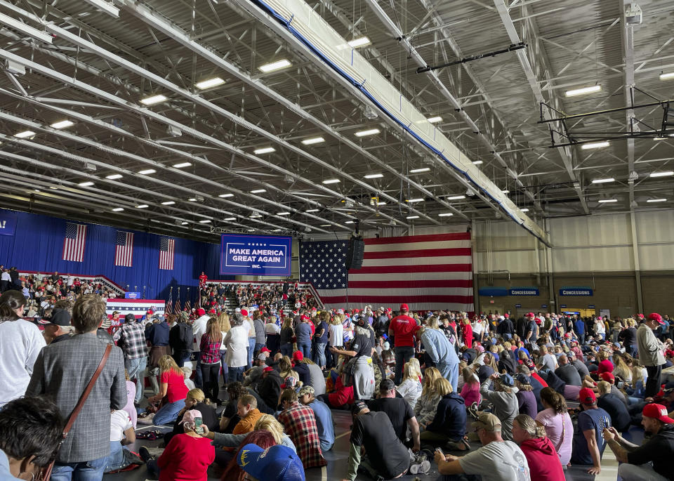 Supporters wait for former President Donald Trump to take the stage at his rally in Warren, Mich., Saturday, Oct. 1, 2022. MyPillow chief executive Mike Lindell and Rep. Marjorie Taylor Greene, R-Ga., also spoke at the event. (AP Photo/Joey Cappelletti)