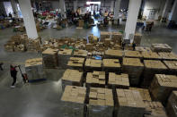 Workers sort out goods to load into trucks at the Chinese online retailer JD.com's warehouse in Beijing on Tuesday, Nov. 9, 2021. China's biggest online shopping day, known as "Singles' Day" on Nov. 11, is taking on a muted tone this year as regulators crack down on the technology industry and President Xi Jinping pushes for "common prosperity." (AP Photo/Andy Wong)