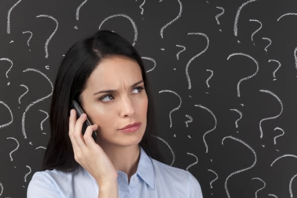 Mobile phone service concept - Woman on the phone with question marks on a blackboard.