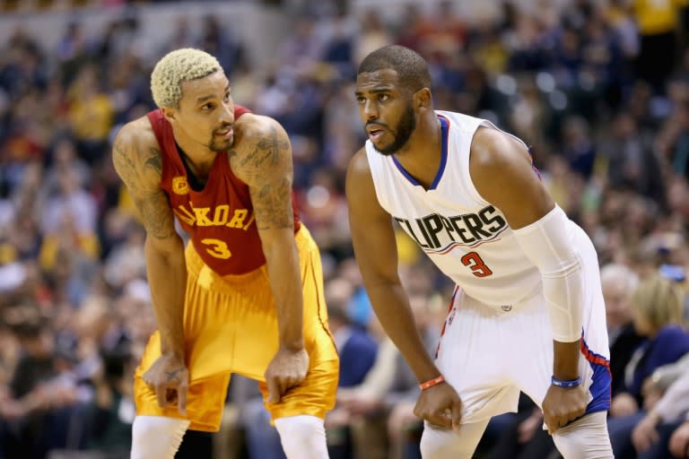 Chris Paul (R) of the Los Angeles Clippers watches the action next to George Hill of the Indiana Pacers during their NBA game at Bankers Life Fieldhouse in Indianapolis, Indiana, on January 26, 2016