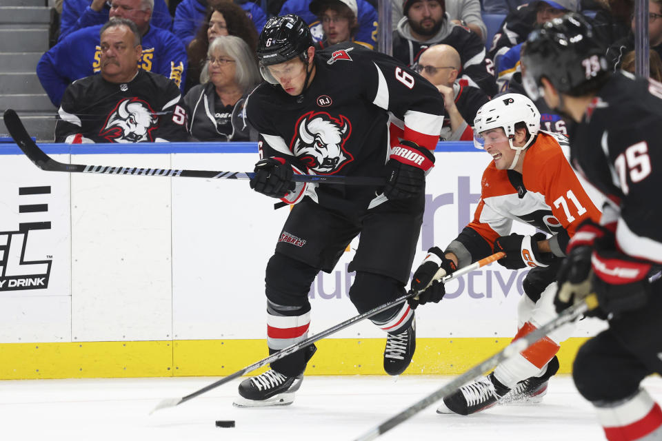 Buffalo Sabres defenseman Erik Johnson (6) is stick-checked by Philadelphia Flyers right wing Tyson Foerster (71) during the second period of an NHL hockey game Friday, Nov. 3, 2023, in Buffalo N.Y. (AP Photo/Jeffrey T. Barnes)