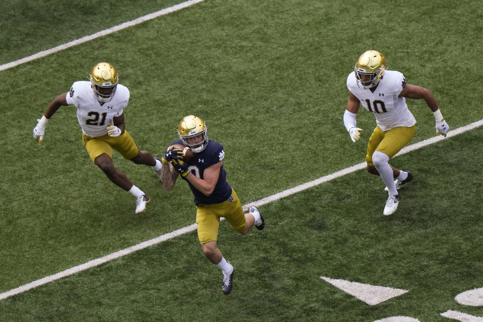 SOUTH BEND, INDIANA - MAY 01: Braden Lenzy #0 of the Notre Dame Fighting Irish catches the football against Caleb Offord #21 and Isaiah Pryor #10 of the Notre Dame Fighting Irish Blue-Gold Spring Game at Notre Dame Stadium on May 01, 2021 in South Bend, Indiana. (Photo by Quinn Harris/Getty Images)
