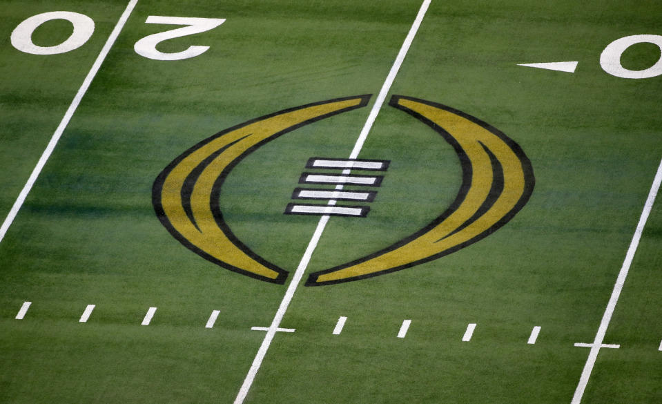 FILE - The College Football Playoff logo is shown on the field at AT&T Stadium before the Rose Bowl NCAA college football game between Notre Dame and Alabama in Arlington, Texas, Jan. 1, 2021. The university presidents who oversee the College Football Playoff voted Friday, Sept. 2, 2022, to expand the postseason model for determining a national champion from four to 12 teams no later than the 2026 season. (AP Photo/Roger Steinman, File)