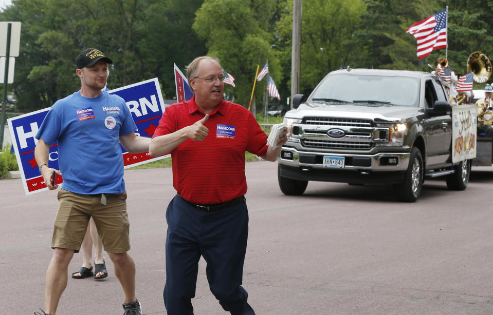 In this June 10, 2018 photo, Minnesota 1st District congressional candidate Jim Hagedorn gives a thumbs up as he works a parade in Waterville, Minn. Waterville's 54th annual Bullhead Days parade included Republican Hagedorn and Democrat Dan Feehan, candidates who came to shake as many hands as they could in the open seat race which promises to be one of the most closely watched races in the country. (AP Photo/Jim Mone)