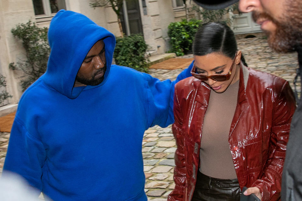 Ye touching Kim's shoulders