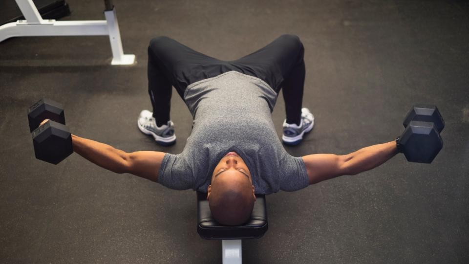 Man performs dumbbell chest flye