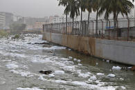 In this Monday, Dec. 10, 2018 photo toxic froth from industrial pollution floats on Bellundur Lake in Bangalore, India. As politicians haggle at a U.N. climate conference in Poland over ways to limit global warming, the industries and machines powering our modern world keep spewing their pollution into the air and water. The fossil fuels extracted from beneath the earth's crust _ coal, oil and gas _ are transformed into the carbon dioxide that is now heating the earth faster than scientists had expected even a few years ago. (AP Photo/Aijaz Rahi)