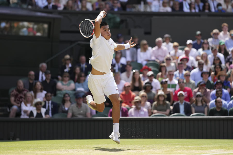 Brandon Nakashima of the US returns to Australia's Nick Kyrgios in a men's singles fourth round match on day eight of the Wimbledon tennis championships in London, Monday, July 4, 2022. (AP Photo/Alberto Pezzali)