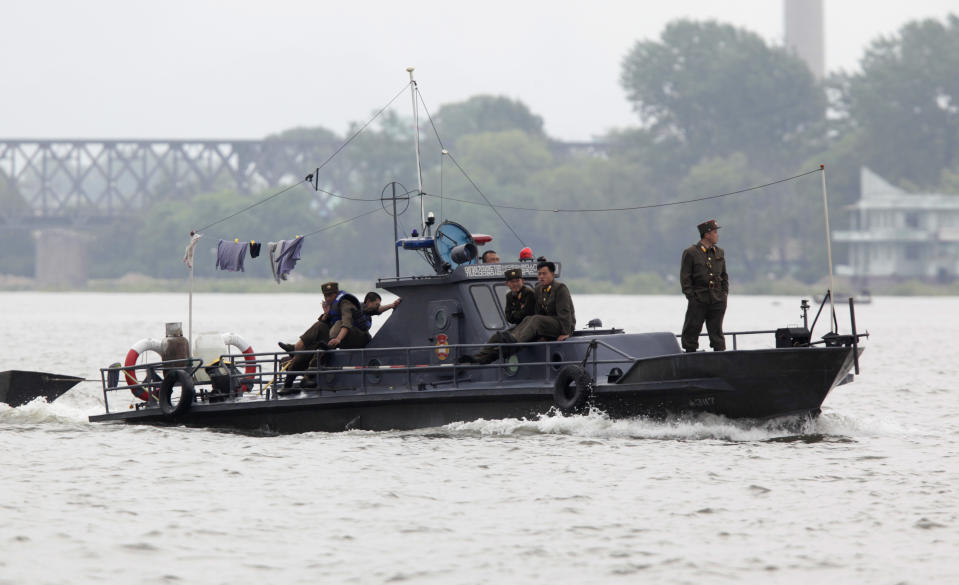 FILE - In this May 29, 2010 file photo, a North Korean patrol boat makes its way along the Yalu river near Dandong in northeastern China's Liaoning province. China's leadership is hitting a rough patch with ally North Korea under its new leader Kim Jong Un, as Beijing finds itself wrong-footed in episodes including Pyongyang's rocket launch and the murky detention of Chinese fishing boats. "The North Koreans are like bandits and robbers," China's Southern Metropolis Weekly newspaper quoted one fisherman as saying Tuesday, May 22, 2012. The story said the hijackers ripped down the Chinese flag on one boat and used it "like a rag." (AP Photo/Ng Han Guan, File)