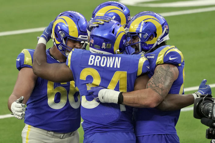Los Angeles Rams running back Malcolm Brown (34) is hugged by teammates after scoring against the Seattle Seahawks during the second half of an NFL football game Sunday, Nov. 15, 2020, in Inglewood, Calif. (AP Photo/Jae C. Hong)