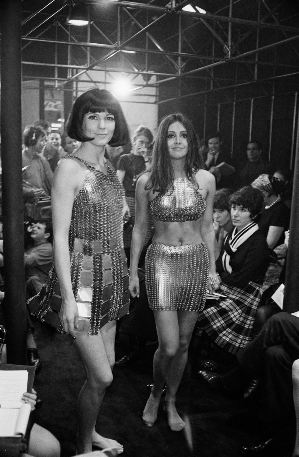 Two Paco Rabanne evening dresses constructed from hundreds of metal rings at a fashion show, 1967 (Getty Images)