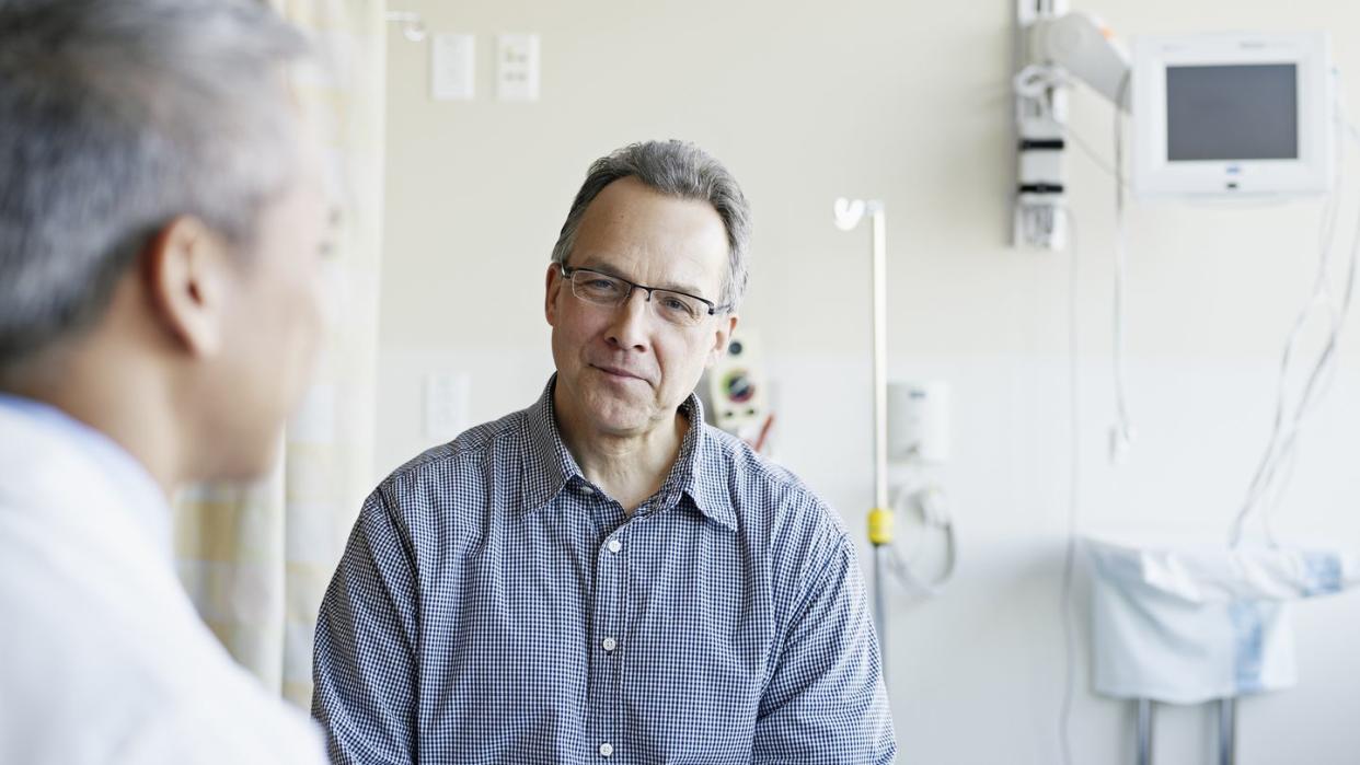 doctor talking to patient in hospital room