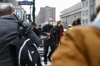 A pedestrian wears a face mask while crossing West 34th Street in New York on Thursday, March 12, 2020. Mayor Bill de Blasio said Thursday he will announce new restrictions on gatherings to halt the spread of the new coronavirus in the coming days, but he hopes to avoid closing all public events such as Broadway shows. (AP Photo/John Minchillo)