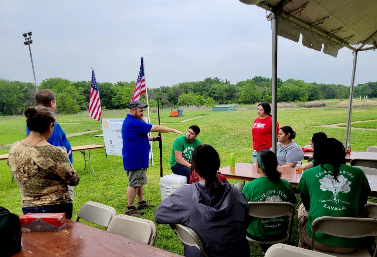 Southwest Rotarian Michael Mitchell provides a firearms safety overview to Road to College Mentors before a clay target shooting event. Road to College Mentors and Rotarians hosted 43 shooters Saturday, April 27, for the 15th annual Southwest Rotary Sporting Clay Shoot east of the SAFB Guardians of Freedom Air Show. Northwest Texas Field and Stream hosted the shooting experience.