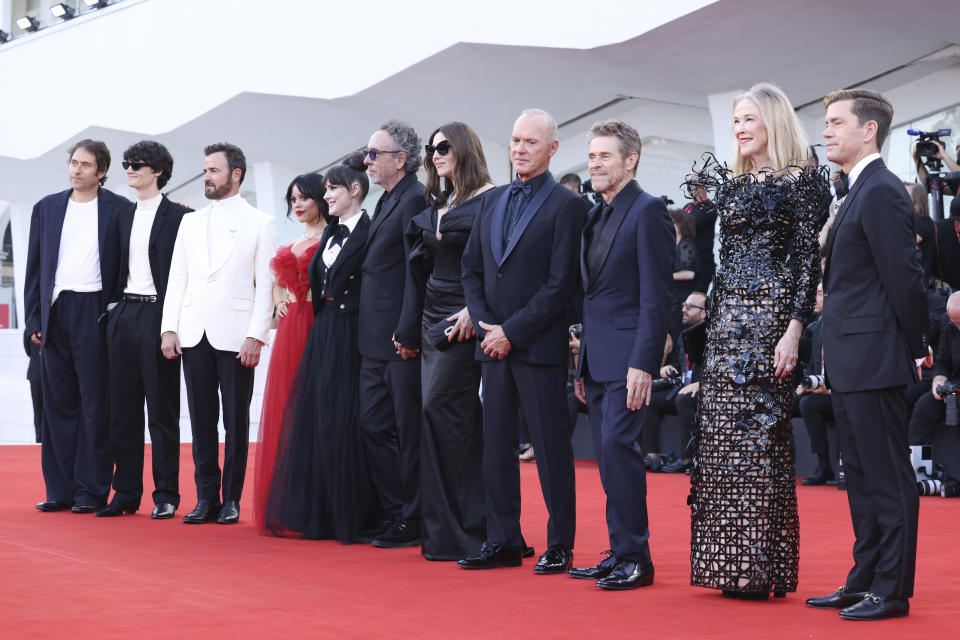 VENICE, ITALY - AUGUST 28:  (L-R) Guest, Arthur Conti, Justin Theroux, Jenna Ortega, Winona Ryder, Tim Burton, Monica Bellucci, Michael Keaton, Willem Dafoe, Cahterine O'Hara and guest attend a red carpet for the movie 