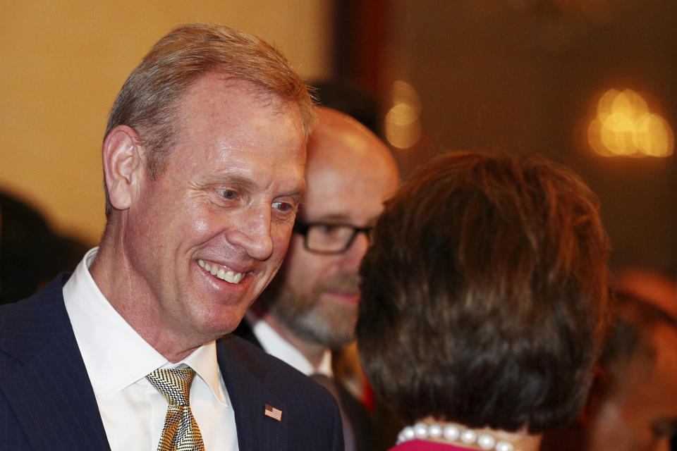 Acting U.S. Secretary of Defense Patrick Shanahan, left, arrives for the opening dinner of the 18th International Institute for Strategic Studies (IISS) Shangri-la Dialogue, an annual defense and security forum in Asia, in Singapore, Friday, May 31, 2019. (AP Photo/Yong Teck Lim)