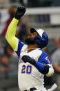 Atlanta Braves' Marcell Ozuna gestures as he crosses home plate after hitting a two-run home run during the first inning of the team's baseball game against the Miami Marlins on Tuesday, April 13, 2021, in Atlanta. (AP Photo/John Bazemore)