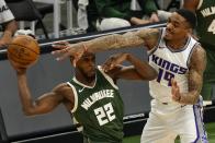 Milwaukee Bucks' Khris Middleton looks to pass around Sacramento Kings' DaQuan Jeffries during the first half of an NBA basketball game Sunday, Feb. 21, 2021, in Milwaukee. (AP Photo/Morry Gash)