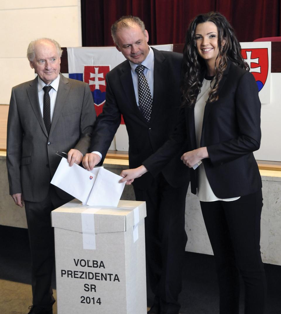 Presidential candidate, businessman and philanthropist Andrej Kiska, center, his father Andrej Kiska Sr., left, and his daughter Natalie Kiskova, right, cast their ballots in the second round of the presidential elections in Poprad, Slovakia, Saturday, March 29, 2014. Kiska´s rival is Slovak Prime Minister Robert Fico, (AP Photo,CTK/Alexander Supik) SLOVAKIA OUT