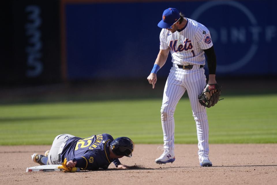 New York Mets' Jeff McNeil (1) exchanges words with Milwaukee Brewers' Rhys Hoskins (12) after Hoskins slid into him during the eighth inning of a baseball game Friday, March 29, 2024, in New York. (AP Photo/Frank Franklin II)