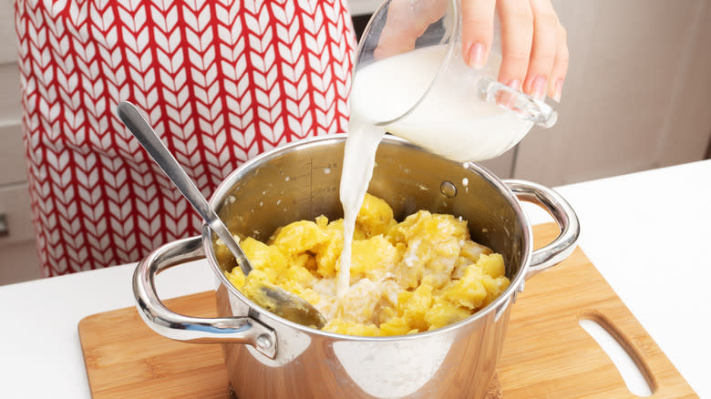 Adding milk to mashed potatoes