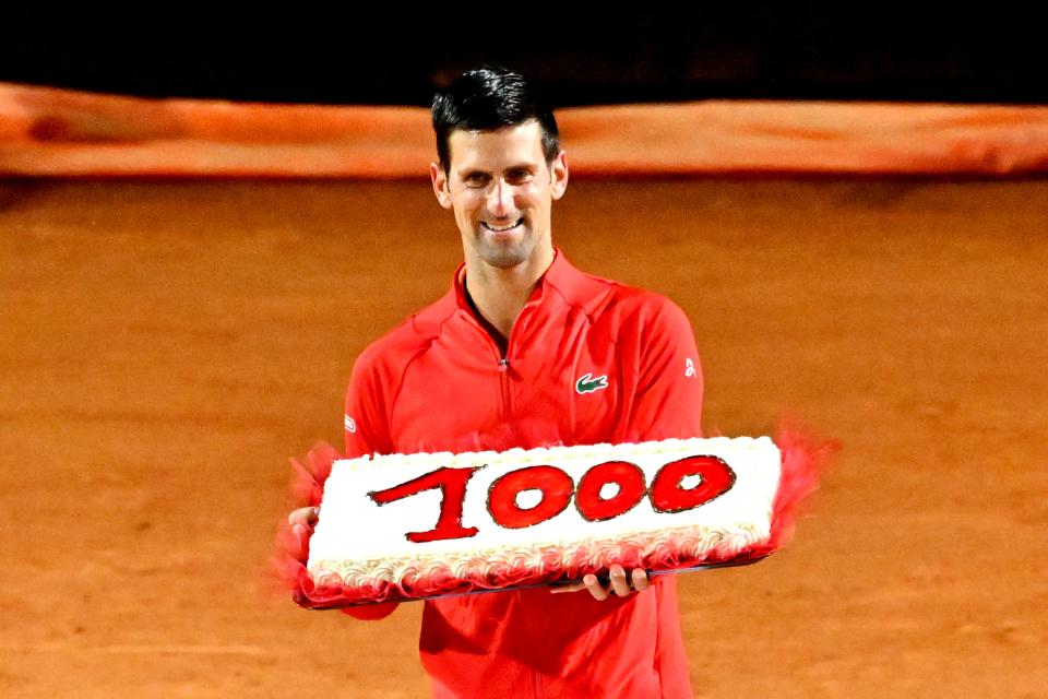 Novak Djokovic, pictured here holding a cake marking his 1000th career win.