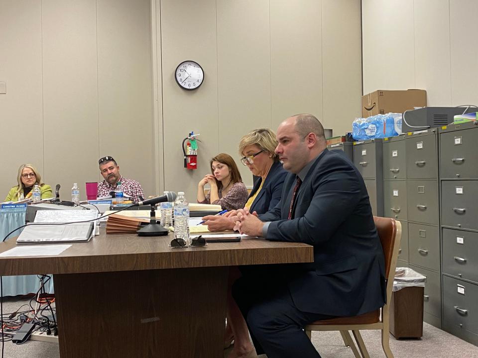 Lafayette Police Sr. Cpl. David Stanley, right, and his attorney Allyson Prejean, left, listen to testimony during an appeal hearing  on Feb. 9, 2022.