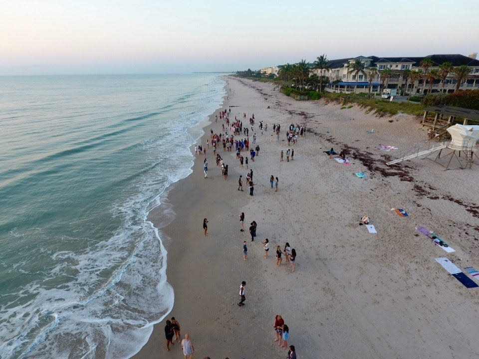 Vero Beach High School students watch the sunrise, Friday, May 10, 2024, at Humiston Beach Park before their last day of school, in this image taken by drone.