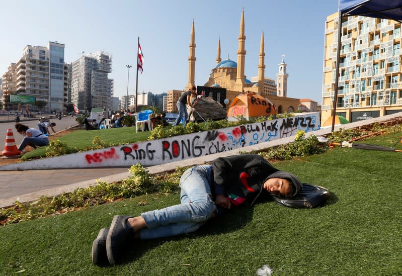A demonstrator is seen sleeping during ongoing anti-government protests in downtown Beirut
