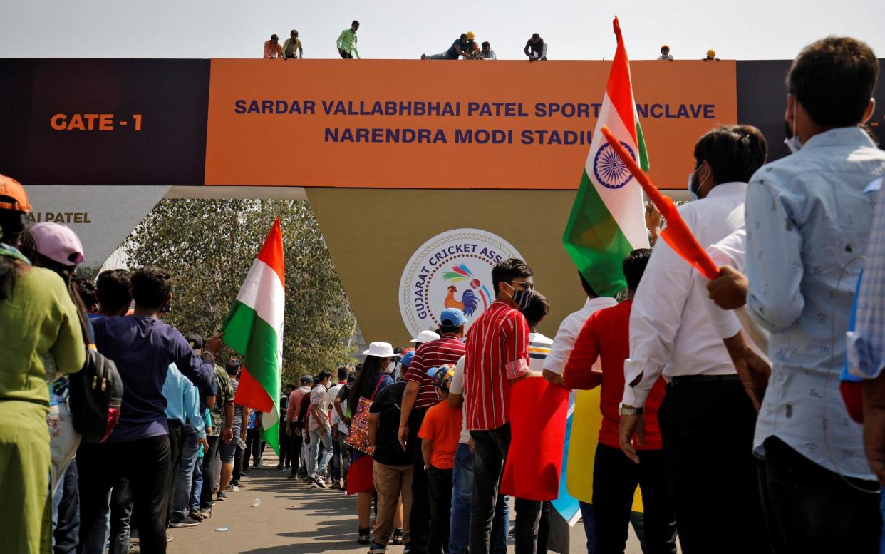 Workers install a hoarding renaming the world's largest cricket stadium after Prime Minister Narendra Modi - REUTERS