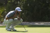 Apr 13, 2018; Hilton Head, SC, USA; Dustin Johnson inspects the green on the 15th hole during the second round of the RBC Heritage golf tournament at Harbour Town Golf Links. Joshua S. Kelly-USA TODAY Sports