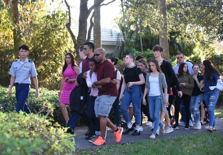 Students react following a shooting at Marjory Stoneman Douglas High School in Parkland, Florida, a city about 50 miles (80 kilometers) north of Miami on February 14, 2018