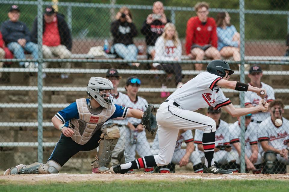New Phla's Mac Steel lays down an RBI sacrifice bunt during a DII East Sectional Championship game against East Liverpool, Tuesday, May 14 at Tuscora Park.