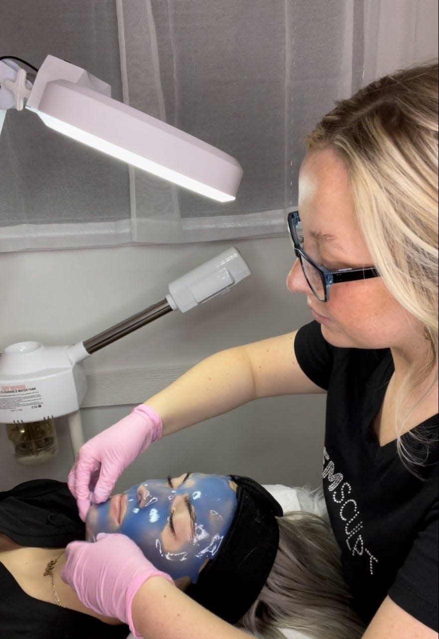 Morgan Craft, an aesthetician at Emerge Medical Spa in Monroe, applies a radiance biotin hydrojelly mask.