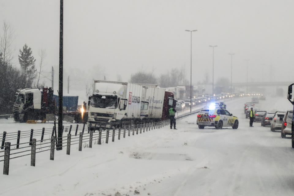 Traffic is brought to a standstill on a main road from Oslo to Gardermoen Airport, after overnight cold weather brought a blanket of snow across the region, in Oslo, Norway, Wednesday Jan. 16, 2019. (Erik Johansen / NTB scanpix via AP)