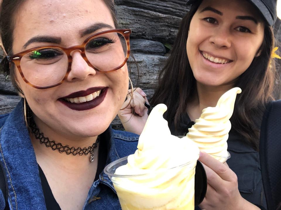 dana and her friend posing with dole whip floats at disneyland