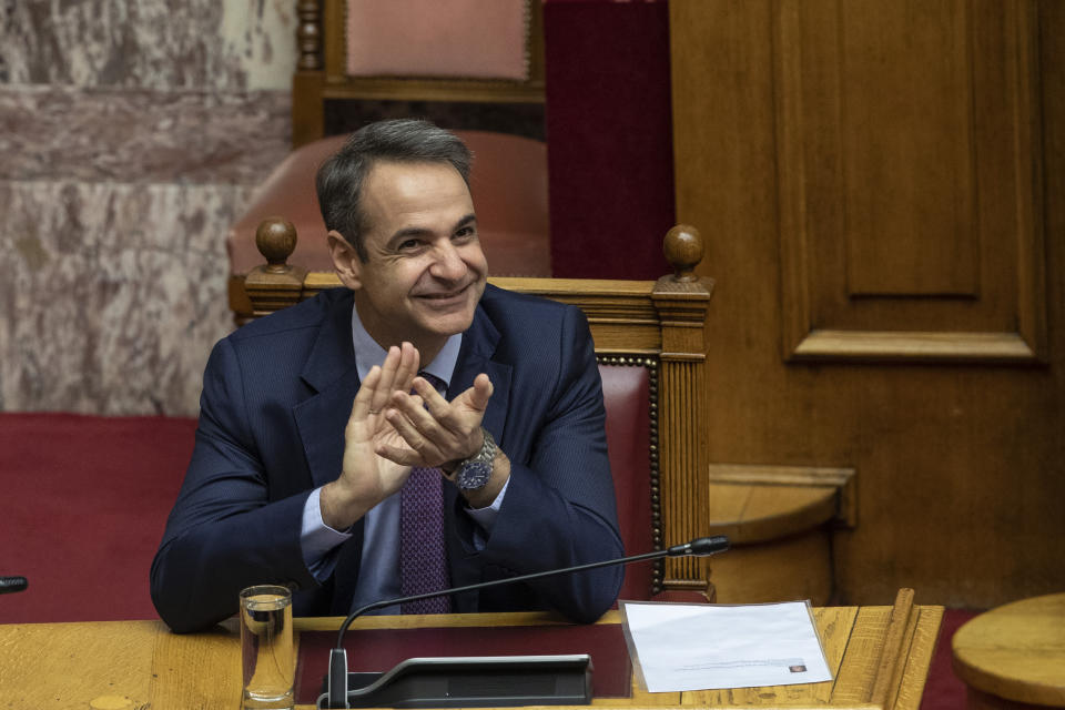 Greek Prime Minister kyriakos Mitsotakis applaud during a parliamentary session to vote for the new Greek President, in Athens, on Wednesday, Jan. 22, 2019. High court judge Katerina Sakellaropoulou has been elected at Greece's first female president with an overwhelming majority in a parliamentary vote. (AP Photo/Petros Giannakouris)