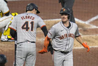 San Francisco Giants' Matt Chapman, right, celebrates with Wilmer Flores as he returns to the dugout after hitting a solo home run off Pittsburgh Pirates relief pitcher Luis L. Ortiz during the seventh inning of a baseball game in Pittsburgh, Tuesday, May 21, 2024. (AP Photo/Gene J. Puskar)