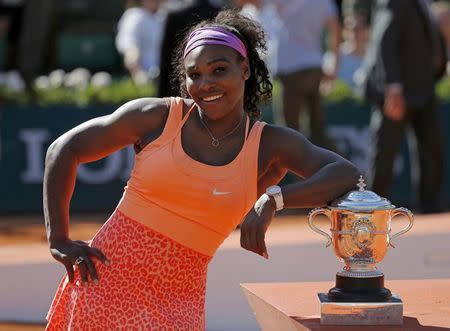 Serena Williams of the U.S. poses with the trophy during the ceremony after defeating Lucie Safarova of the Czech Republic during their women's singles final match to win the French Open tennis tournament at the Roland Garros stadium in Paris, France, June 6, 2015. REUTERS/Vincent Kessler