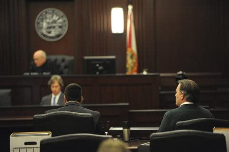 Michael Dunn (R), who faces first-degree murder charges in the death of 17-year-old Jordan Davis, sits with his attorney Cory Strolla while Judge Healey addresses the jury at Duval County Courthouse in Jacksonville, Florida February 6, 2014. REUTERS/Bob Mack/The Florida Times-Union/Handout