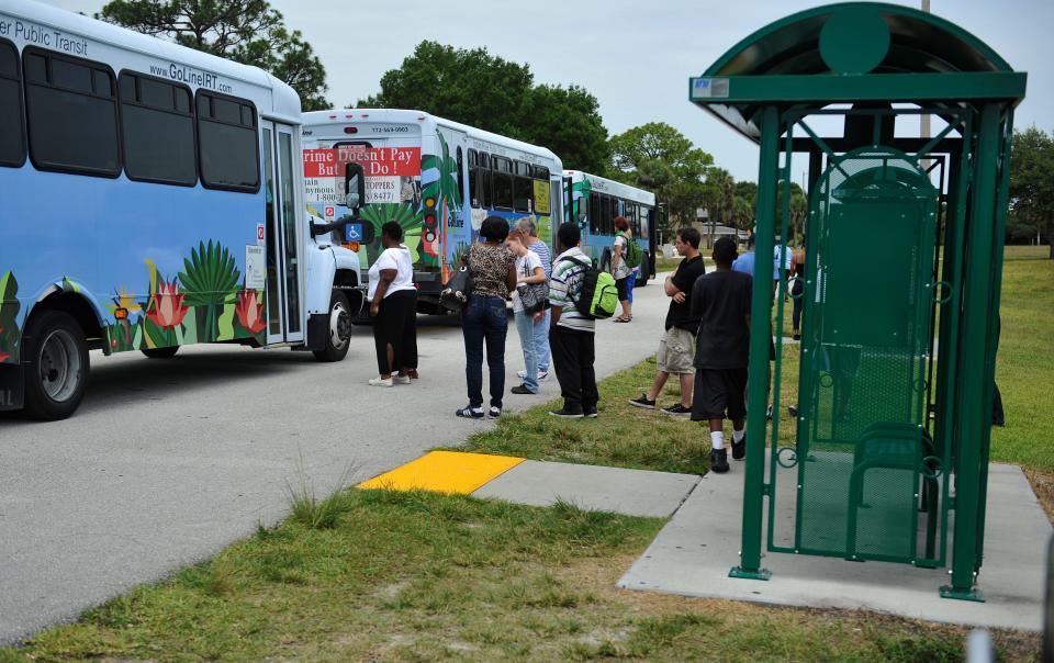 Riders congregate Thursday June 11, 2015 at GoLine's Main Transit Hub located at the Vero Beach Municipal Airport, which connects with 7 of the GoLine's 15 bus routes. Many of the GoLine's bus stops are on grass, not near sidewalks, and are not covered.