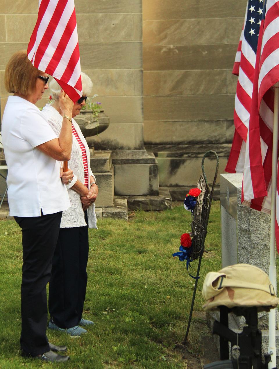 Norma Studebaker, left, of the AMVETS Auxiliary stands with Honoray Mother Shirley Wiegers after Wiegars placed the wreath at the grave marker.