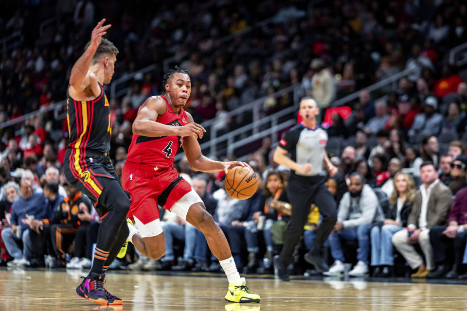 Toronto Raptors forward Scottie Barnes (4) drives against Atlanta Hawks' Bogdan Bogdanovic during the first half of an NBA basketball game Friday, Feb. 23, 2024, in Atlanta. (AP Photo/Jason Allen)