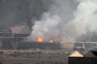 Flames and smoke billow from the site of an explosion that hit an arms depot in Yemen's second city of Aden on March 28, 2015