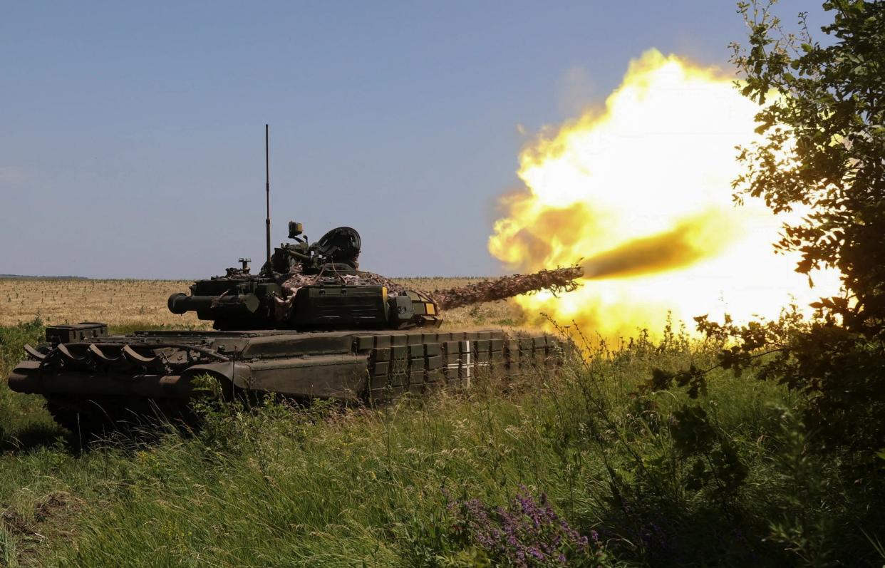 Ukrainian servicemen fire with a tank towards Russian troops near a front line, amid Russia's attack on Ukraine, in Kharkiv region (REUTERS)