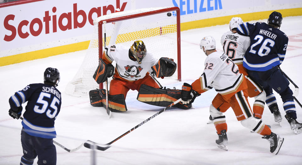 Winnipeg Jets' Mark Scheifele (55) scores on Anaheim Ducks goaltender Anthony Stolarz (41) during the third period of an NHL Hockey game in Winnipeg, Manitoba on Sunday, Dec. 4, 2022. (Fred Greenslade/The Canadian Press via AP)