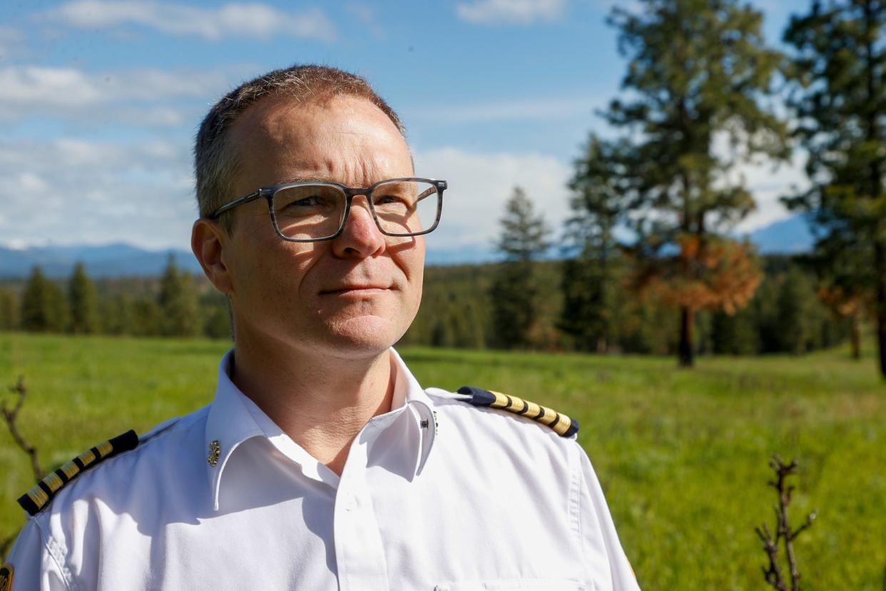 Scott Driver, the director of Cranbrook Fire and Emergency Services at the Canadian Rockies International Airport, stands in an area that was part of a prescribed burn at the airport to help rid the forest area of fuel that would feed a potential fire from dried leaves to twigs and dried pine needles in Cranbrook, British Columbia, Canada on Thursday, May 30, 2024.