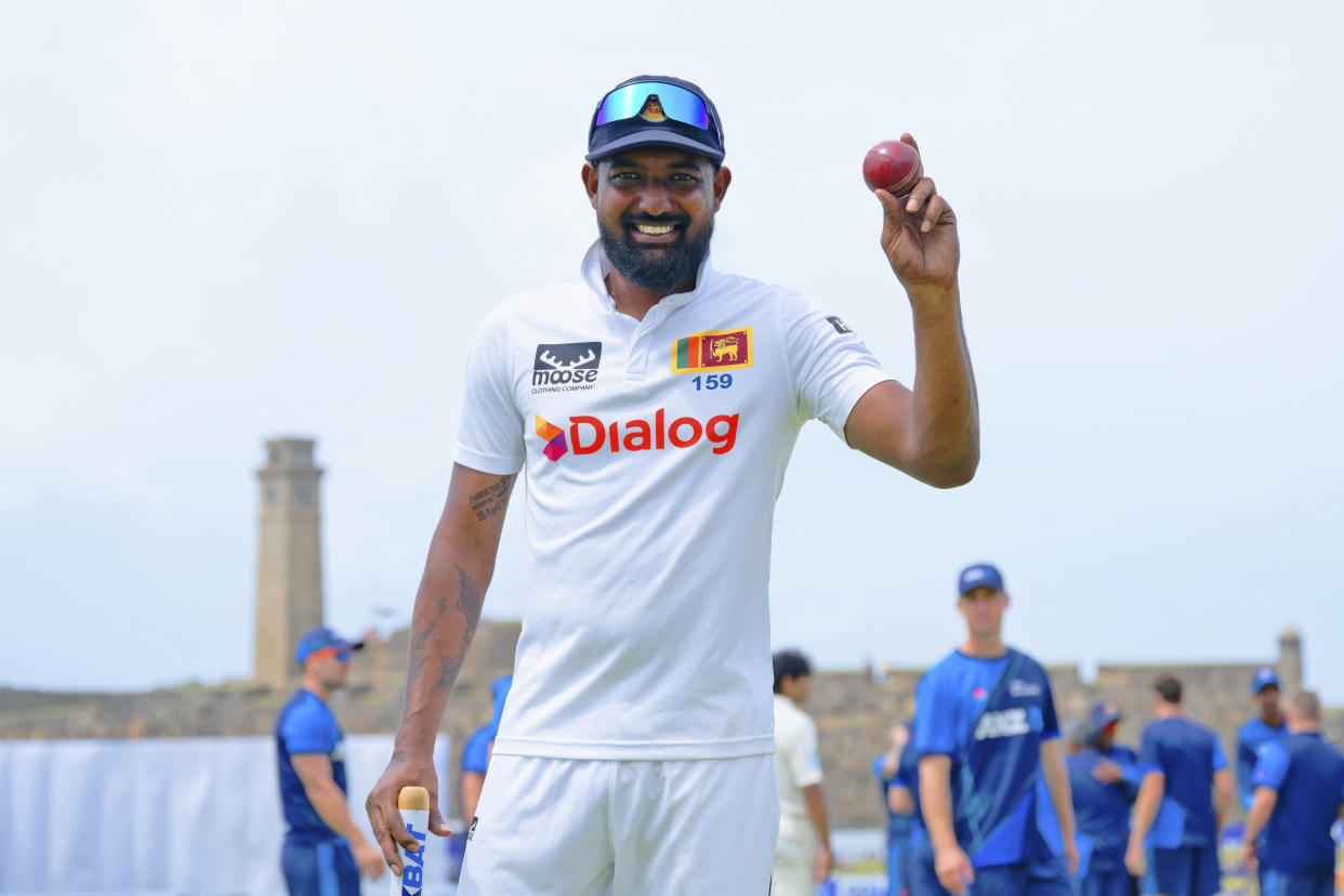 Sri Lanka's Prabath Jayasuriya displays the ball to celebrate his five-wicket haul in the second innings after Sri Lanka won the first cricket test match against New Zealand in Galle, Sri Lanka, Monday, Sept. 23, 2024. (AP Photo/Viraj Kothalawala)