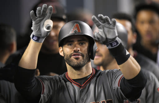 J.D. Martinez gestures toward the camera after hitting his MLB record tying fourth home run in the Diamondbacks 13-0 win against the Dodgers. (AP)